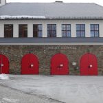 a row of red doors in front of a building